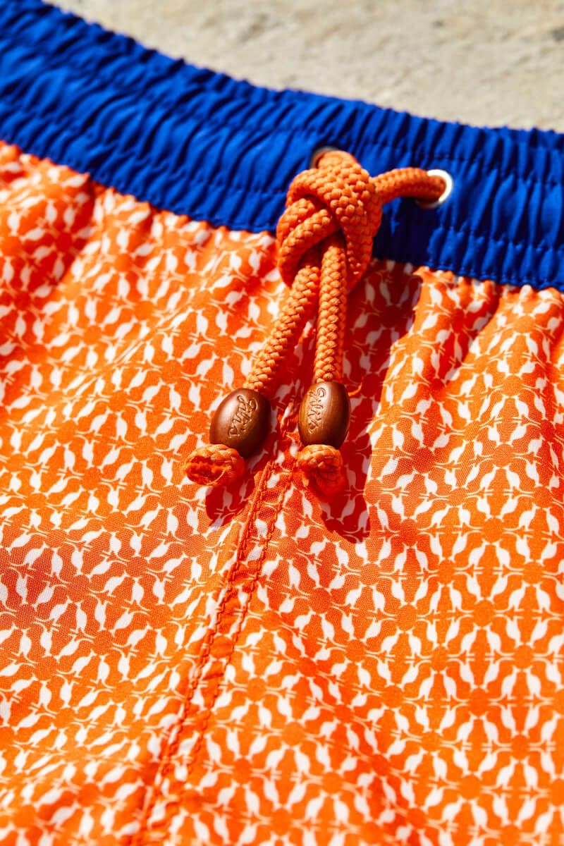 Man wearing a Orange Kangaroos swimsuit with elasticated belt