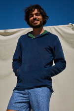 man wearing a navy terry cloth sweat