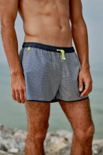 Man wearing a short swimsuit Komodo Navy Azulejos